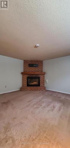 12 Simmons Blvd, Brampton, ON - Indoor Photo Showing Other Room With Fireplace