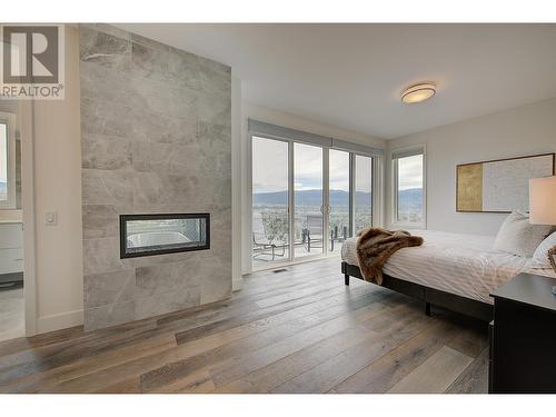 737 Highpointe Drive, Kelowna, BC - Indoor Photo Showing Bedroom With Fireplace