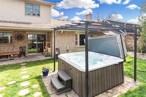 There are fairly lights on the pergola for starry nights in the tub. - 64 Terrace Drive, Dundas, ON - Outdoor With Exterior