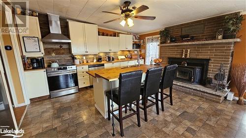 114 Robbs Rock Road, Burk'S Falls, ON - Indoor Photo Showing Kitchen With Fireplace