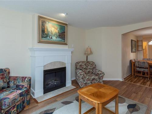207-5660 Edgewater Lane, Nanaimo, BC - Indoor Photo Showing Living Room With Fireplace