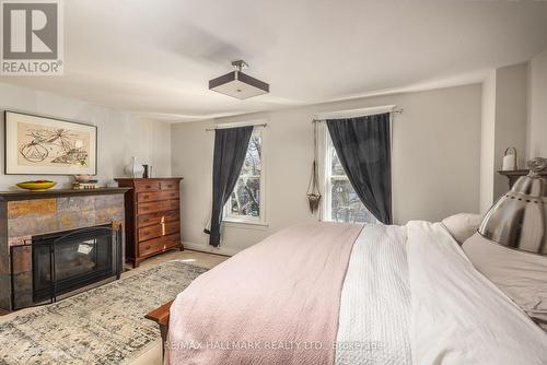18 Pape Avenue, Toronto, ON - Indoor Photo Showing Bedroom With Fireplace