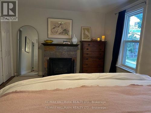 18 Pape Avenue, Toronto, ON - Indoor Photo Showing Bedroom With Fireplace