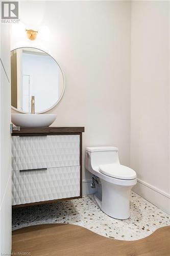 Powder room with custom flooring - 147 Blue Jay Crescent, Grey Highlands, ON - Indoor Photo Showing Bathroom