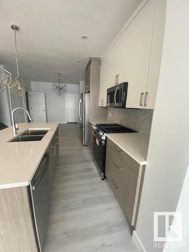 #Main 8070 Kiriak Li Sw, Edmonton, AB - Indoor Photo Showing Kitchen With Stainless Steel Kitchen With Double Sink With Upgraded Kitchen