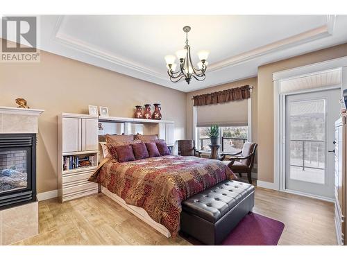 1297 Tanemura Crescent, Kelowna, BC - Indoor Photo Showing Bedroom With Fireplace