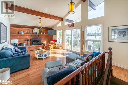 Lots of natural light. - 562 & 568 E Waseosa Lake Road, Huntsville, ON - Indoor Photo Showing Living Room With Fireplace