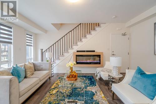 #48 -45 Knotsberry Circ, Brampton, ON - Indoor Photo Showing Living Room With Fireplace