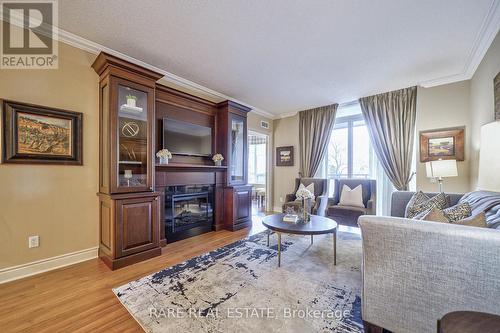 #320 -10101 Yonge St, Richmond Hill, ON - Indoor Photo Showing Living Room With Fireplace