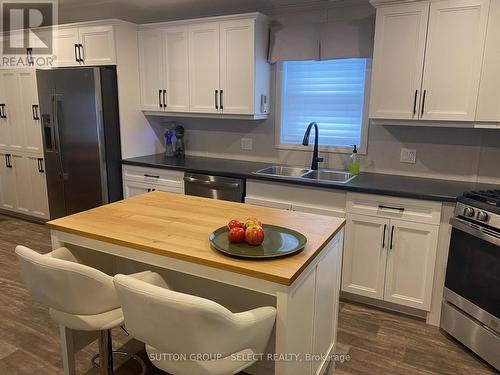 Island with stools - 55 - 22790 Amiens Road, Middlesex Centre (Komoka), ON - Indoor Photo Showing Kitchen With Double Sink