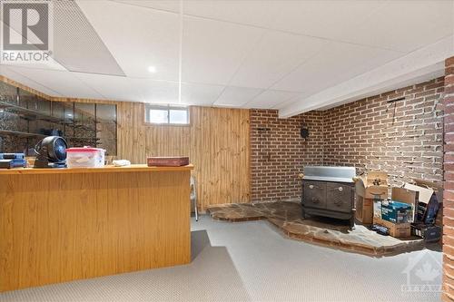 Wet bar & wood stove - 4145 Champlain Street, Bourget, ON - Indoor Photo Showing Basement