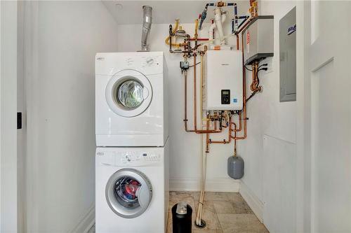updated tankless water system, & in-suite laundry - 397 King Street W|Unit #104, Dundas, ON - Indoor Photo Showing Laundry Room