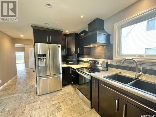 357 7Th Avenue W, Melville, SK - Indoor Photo Showing Kitchen With Double Sink