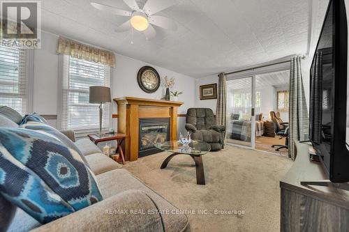 #9 -580 Beaver Creek Rd, Waterloo, ON - Indoor Photo Showing Living Room With Fireplace