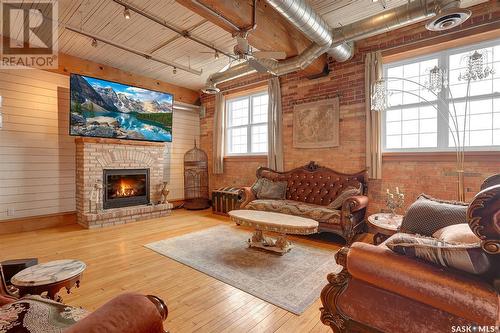 204 1170 Broad Street, Regina, SK - Indoor Photo Showing Living Room With Fireplace