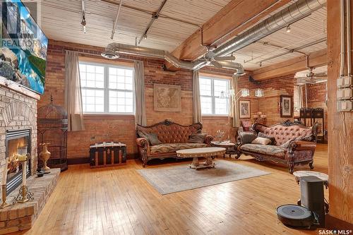 204 1170 Broad Street, Regina, SK - Indoor Photo Showing Living Room With Fireplace