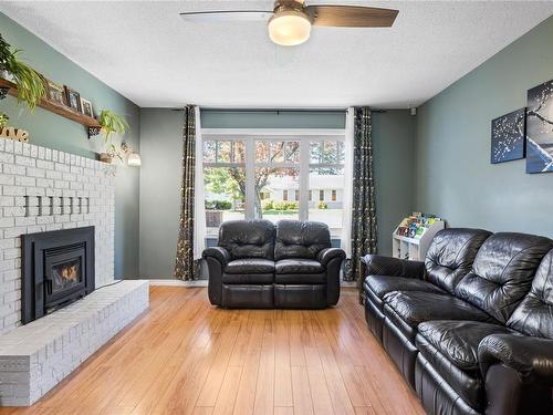 597 Karls Way, French Creek, BC - Indoor Photo Showing Living Room With Fireplace