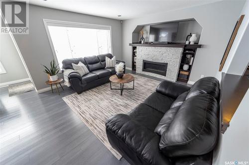19 Plains Road, Pilot Butte, SK - Indoor Photo Showing Living Room With Fireplace