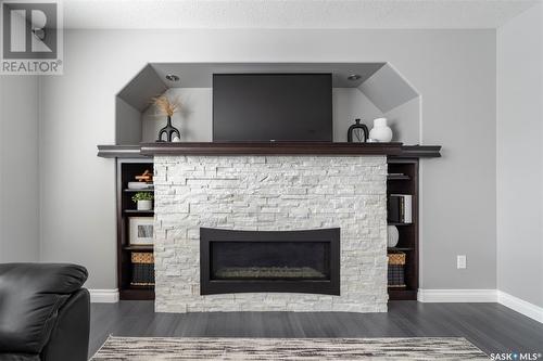 19 Plains Road, Pilot Butte, SK - Indoor Photo Showing Living Room With Fireplace