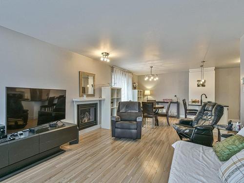 Overall view - 102-18 Rue Louis-Jolliet, Saint-Jérôme, QC - Indoor Photo Showing Living Room With Fireplace