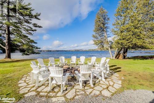 Firepit at beach - 3876 Muskoka 118 Road W Unit# Sandfield 1 Week 3, Port Carling, ON - Outdoor With Body Of Water With View