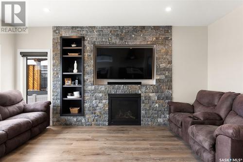114 Vestor Drive, Pilot Butte, SK - Indoor Photo Showing Living Room With Fireplace