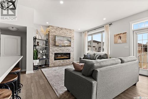 4832 Primrose Green Drive E, Regina, SK - Indoor Photo Showing Living Room With Fireplace