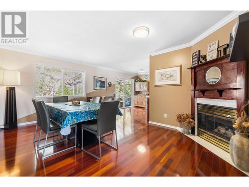 1056 Caledonia Way, West Kelowna, BC - Indoor Photo Showing Dining Room With Fireplace