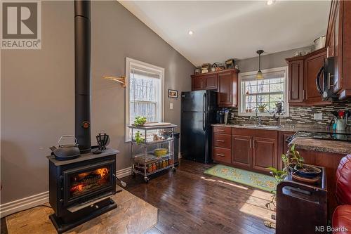 7 Holland Lane, Cambridge-Narrows, NB - Indoor Photo Showing Kitchen With Fireplace With Double Sink