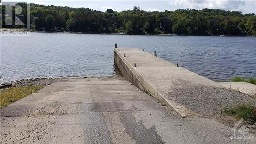 Public boat launch 2 minute drive located at Bayview Drive & Ritchie Street - 215 Fireside Drive, Constance Bay, ON - Outdoor With Body Of Water With View