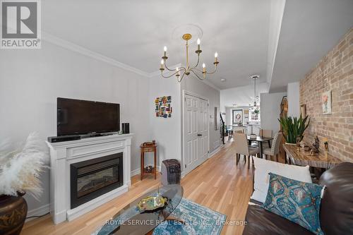 #303 -79 King St W, Cobourg, ON - Indoor Photo Showing Living Room With Fireplace