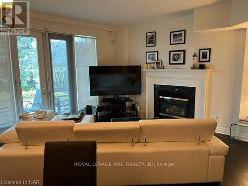 #109S -225 Ricardo St, Niagara-On-The-Lake, ON - Indoor Photo Showing Living Room With Fireplace