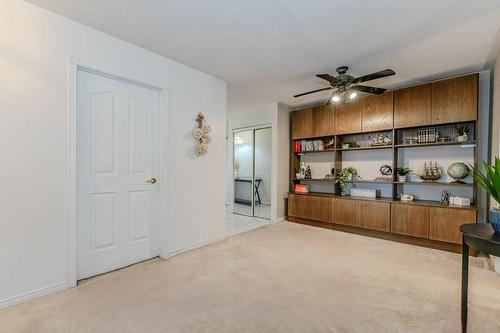 Built in entertainment unit to provide display area, book shelf and additional storage. - 3050 Pinemeadow Drive|Unit #57, Burlington, ON - Indoor Photo Showing Other Room