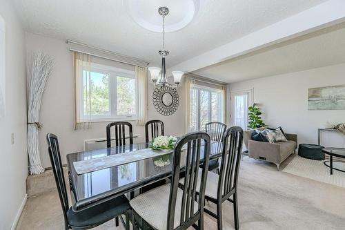 Dining room is open to the living room... extend the table for those large family gatherings! - 3050 Pinemeadow Drive|Unit #57, Burlington, ON - Indoor Photo Showing Dining Room
