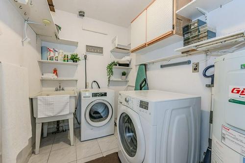 In suite laundry with space for cleaning supplies, tools and more! - 3050 Pinemeadow Drive|Unit #57, Burlington, ON - Indoor Photo Showing Laundry Room