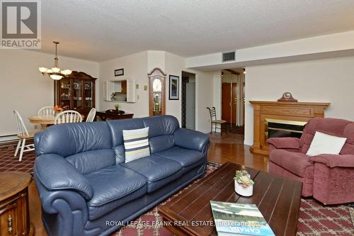 #113 -1 Heritage Way, Kawartha Lakes, ON - Indoor Photo Showing Living Room With Fireplace