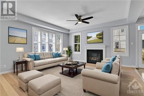 This photo is virtually staged. - 227 Kohilo Crescent, Stittsville, ON - Indoor Photo Showing Living Room With Fireplace