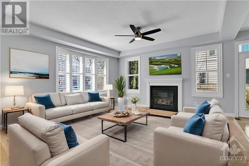 This photo is virtually staged. - 227 Kohilo Crescent, Stittsville, ON - Indoor Photo Showing Living Room With Fireplace