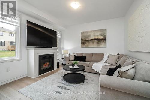 31 Dass Dr W, Centre Wellington, ON - Indoor Photo Showing Living Room With Fireplace