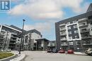 #216 -102 Grovewood Common Cres, Oakville, ON  - Outdoor With Balcony With Facade 