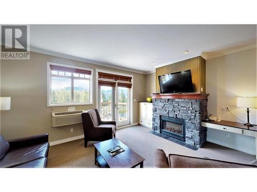 200 Bighorn  Boulevard Unit# 234 A, Radium Hot Springs, BC - Indoor Photo Showing Living Room With Fireplace