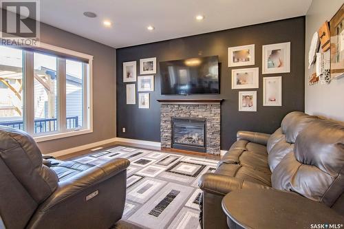 206 Blackstock Cove, Saskatoon, SK - Indoor Photo Showing Living Room With Fireplace