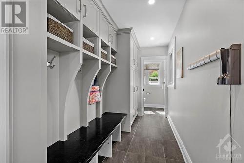 Mudroom with heated floors, Deslaurier cabinetry, access to garage and backyard. - 10 Okanagan Drive, Ottawa, ON - Indoor Photo Showing Other Room