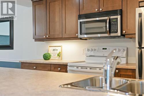 #104 -323 George St, Cobourg, ON - Indoor Photo Showing Kitchen With Double Sink