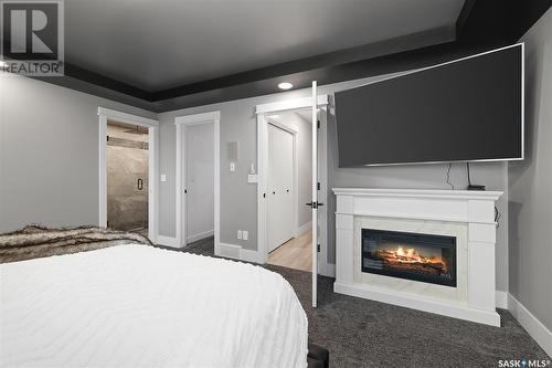 411 Braeside Bay, Saskatoon, SK - Indoor Photo Showing Bedroom With Fireplace