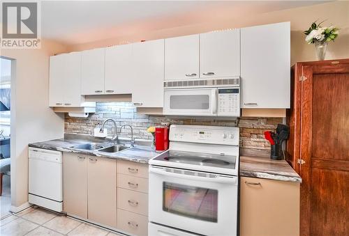 Plenty of kitchen storage available ... - 19 John Street E Unit#203, Perth, ON - Indoor Photo Showing Kitchen With Double Sink