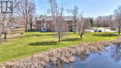 Beautiful waterfront + landscaped grounds ... - 19 John Street E Unit#203, Perth, ON - Outdoor