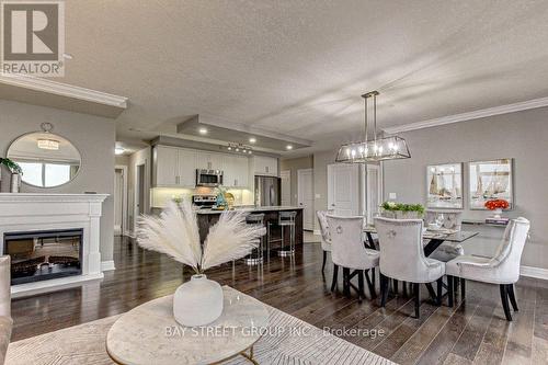 605 - 240 Villagewalk Boulevard, London, ON - Indoor Photo Showing Dining Room With Fireplace