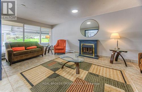 #607 -58 Bridgeport Rd E, Waterloo, ON - Indoor Photo Showing Living Room With Fireplace