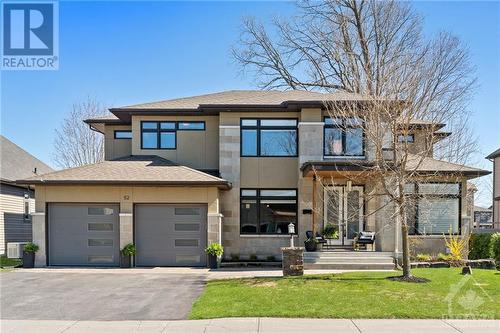 As you approach this stunning Inverness home on Moore St. in Richmond, prepare to be captivated by its unparalleled curb appeal, offering a bespoke experience that sets the stage for luxury living - 52 Moore Street, Ottawa, ON - Outdoor With Facade